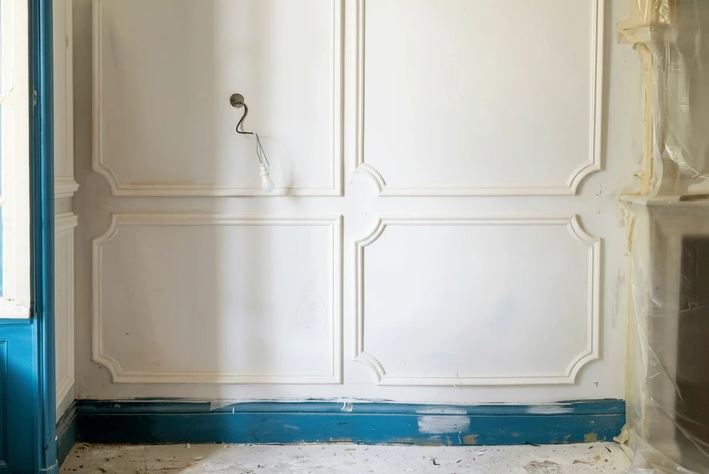 Chantier intérieur en cours de finition : plafond à caisson en plaques de plâtre BA13 bleu (Knauf ou Placo Phonique), avec joints enduits partiellement, moulures d'encadrement en staff blanc
